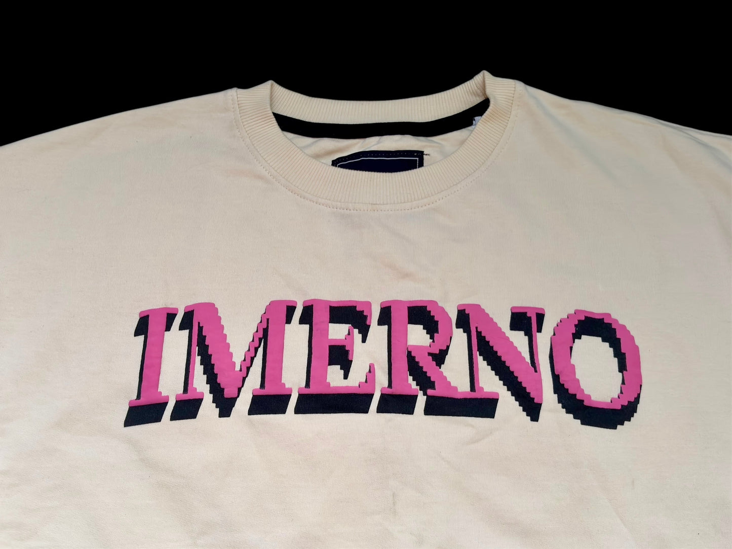 Close-up of IMERNO screen-printed 3D pixel logo on cream streetwear tee – bold branding from one of India’s fastest growing Gen Z streetwear labels.